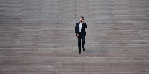 Businessman step up upward on stairs. Man stepping toward professional growth and success. Step by step toward career achievement. Business man climbing stairs. Step to business goals.