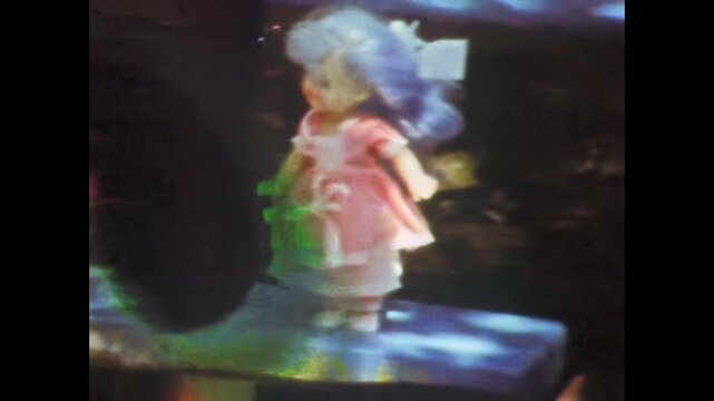 Old archive, abandoned children doll standing outdoors, close up. Children toys for girls. Childhood gone by. Days long gone. Soviet children toy. Old film. Archival retro 1960s. Vintage archive. 