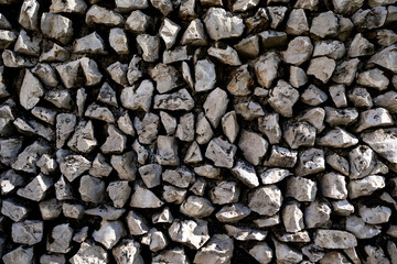Stone wall texture. Detailed stone surface in rustic wall. Textured rock wall pattern up close. Natural stone blocks with rough texture. Stone masonry wall.