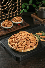 Fresh Raw Peanuts in Shell with Red Skin in Bamboo Basket on Wooden Table