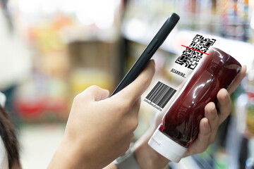 Smartphone scanning product QR and barcode in supermarket showing digital data access for smart shopping