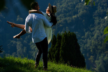 The sexy couple embraced passionately amidst the beauty of nature. Carefree and deeply in love, the couple enjoyed each other's company in the open air. The romantic couple in love on summer nature.