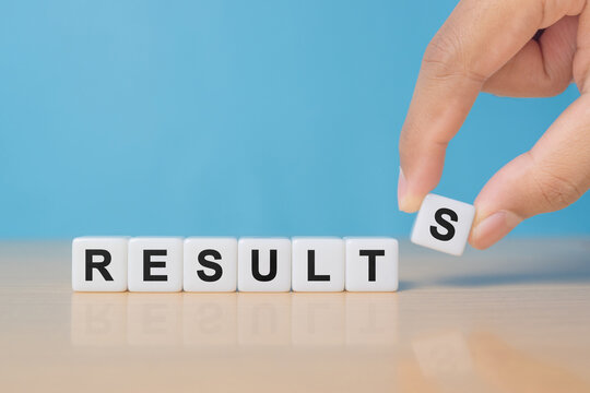 Businessman puts dice with the word Results. The concept of annual financial statements. Analysis of profits and revenues in the company. Achievements of the business team.