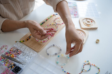 Senior mature older asian woman Art hobby handmade making beads jewellery accessories handcraft...