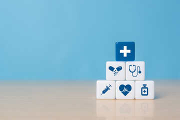 Health insurance concept, dice with healthcare medical icons on blue background, copy space