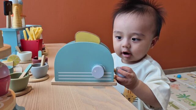 A cute little child smiles happily while playing with toys made from wood and non-toxic paint to enhance their development.