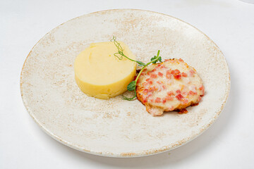 This dish offers creamy mashed potatoes paired with a cheesy ham bake for a perfect meal
