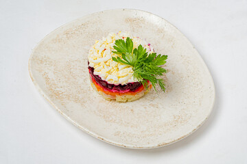 A vibrant layered salad presents colorful ingredients, elegantly arranged on a simple plate