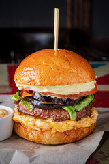 Juicy burger stacked with grilled vegetables, lettuce, and a special sauce, ready to savor