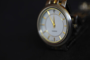 Close-Up of Elegant Luxury Wristwatch with Gold Accents on Black Background