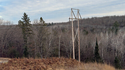 Fototapeta premium Autumn in the mountains of the Michigan Upper Peninsula along a high-voltage power line corridor.