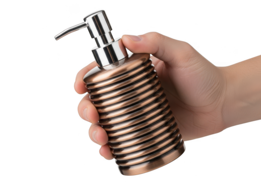 Hand holding a decorative bronze ribbed soap dispenser with a metal pump mechanism isolated on transparent background