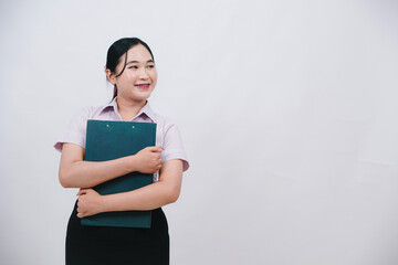 Happy young woman holding a folder with a smile in a professional setting, promoting confidence and readiness for work or study opportunities
