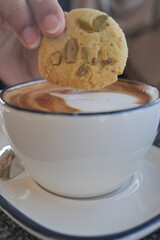 Enjoying a cookie with a cup of coffee in a cozy cafe