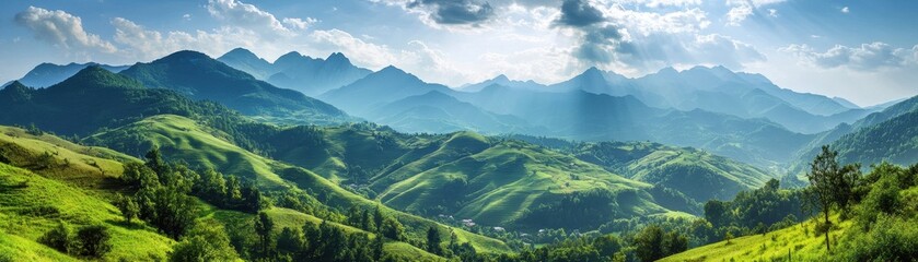 Breathtaking panoramic view of green mountains under a blue sky.