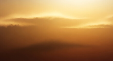 Golden atmospheric sky with subtle clouds at sunrise or sunset