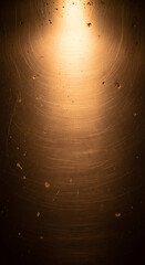 Grungy scratched metal texture with warm golden light effect glow