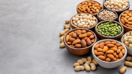 Almond and mixed nuts in bowls on gray table evoking healthy snack enjoyment