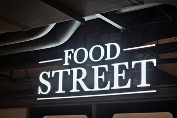 Modern Food Street sign on dark background.