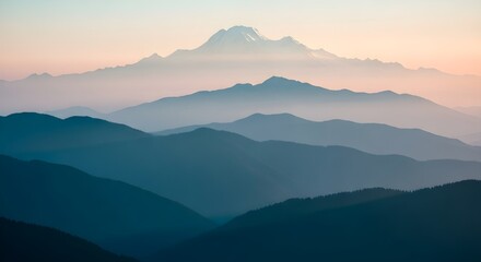 Obraz premium A breathtaking view of mountain ranges at sunset, with the peaks fading into the distance and a soft, warm light casting a serene glow over the landscape