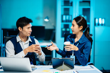 Asian colleagues discussing project plans and reviewing documents in a modern office. Concept of business teamwork, strategy