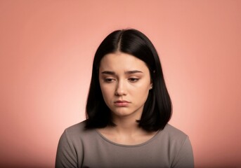 Fototapeta premium A portrait of a young woman expressing sadness and showing vulnerability.