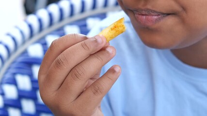 Kid enjoying a tasty french fries on a sunny day