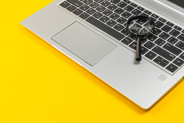 Exploring detailed analysis with a magnifying glass on a laptop