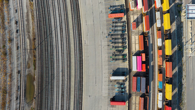 Top down view of curved Train tracks , containers, container chassis at logistics hub in Columbus, ohio.