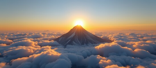 Majestic mountain peak rising above vibrant clouds at sunrise.