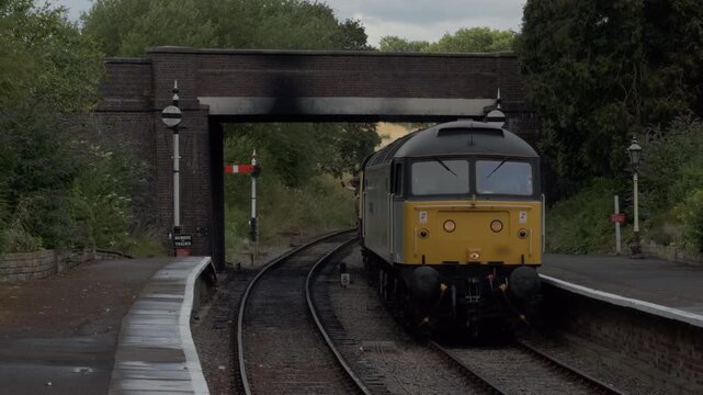 Diesel train front approaching station on a sunny day