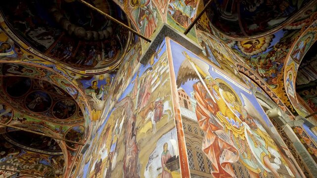 Interior view of Rila Monastery in Bulgaria, featuring intricate frescoes and sacred paintings, Orthodox art and rich cultural heritage low angle view
