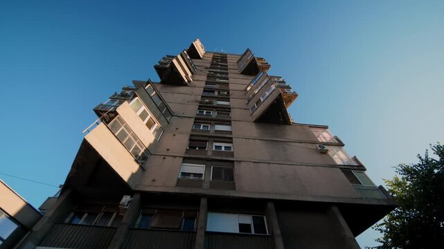 Low-angle aerial view of Belgrade&rsquo;s Houding Tower in Karaburma, Serbia, highlighting brutalist architecture, geometric concrete design, and urban skyline perspective