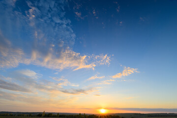 A breathtaking and beautiful sunrise gracefully illuminates a serene and picturesque landscape