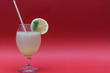 natural lemon juice isolated on red background