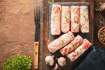 Tarb is a Middle Eastern dish that combines minced meat, onions and various spices. It wrapped in a layer of lamb fat and ready for grilling.