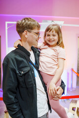 Father and daughter share a joyful moment indoors