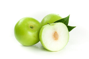Fresh Green Jujube Dates Cut in Half Showing Flesh and Pit with Leaves