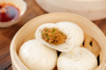 Handmade Steamed Pork Buns with Scallions in Bamboo Steamer - Traditional Asian Dim Sum Cuisine