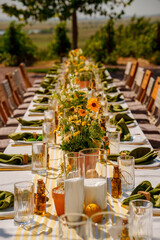 Elegant outdoor dining setup with flowers and greenery