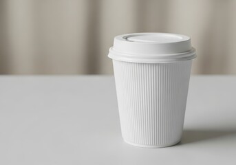 Blank white paper coffee cup with lid on a clean surface studio shot