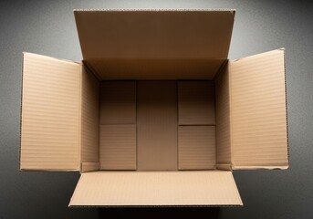 Open empty cardboard box viewed from above ready for shipping or storage on a dark surface