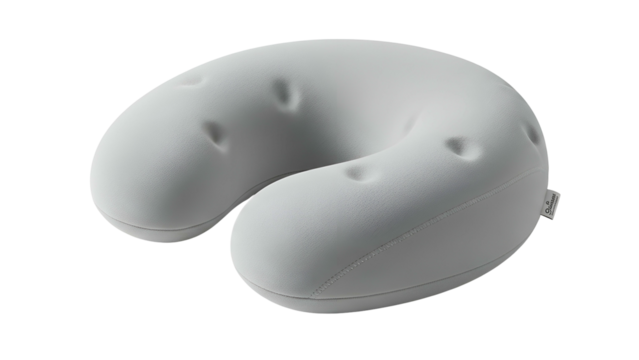 A light gray, ergonomic travel pillow in a U-shape, with indented features