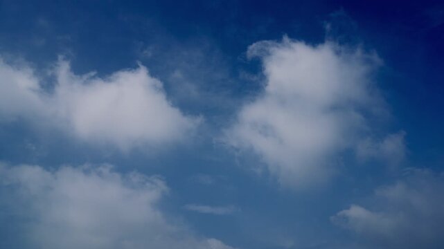 Deep sky with bright sunlight illuminating soft cloud edges  recorded at normal speed showcasing atmospheric depth cloud motion natural lighting shifts and real time movement perfect for nature projec