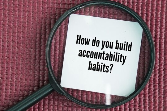 Magnifying glass with the question word How do you build accountability habits?