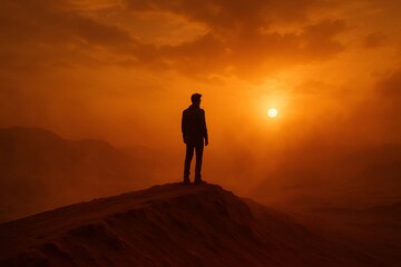 Man standing on hill during orange sunset