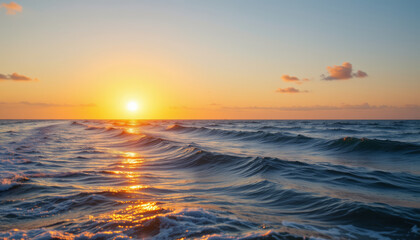 Sunset over calm ocean waves with golden light reflecting on water, creating peaceful and serene atmosphere