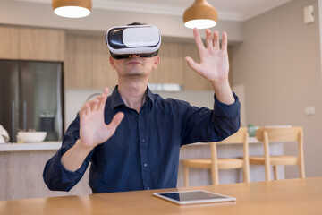man using virtual reality headset indoors, interacting with invisible interface. Concept of immersive technology, VR innovation, digital experience futuristic user interaction.