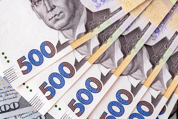 Background with Ukrainian money and American dollars.American dollars and Ukrainian hryvnias. Concept of American aid to Ukraine in the war. Concept of the exchange rate.