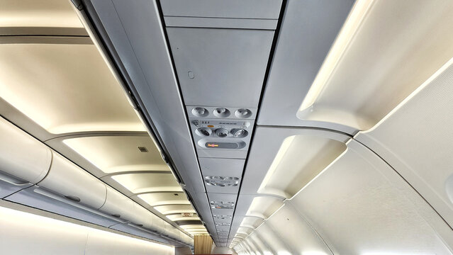 overhead panel and cabin ceiling of a commercial airplane. the cabin environment is a carefully controlled system designed for passenger safety and comfort